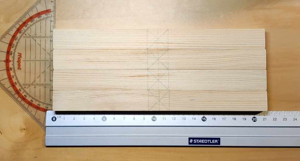 The square timbers marked for the X-like assembly